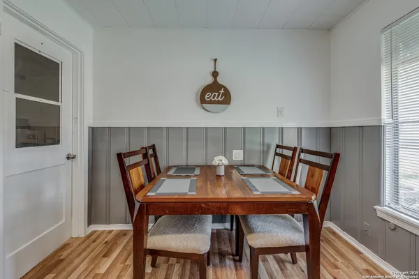a view of a dining room with furniture window and wooden floor