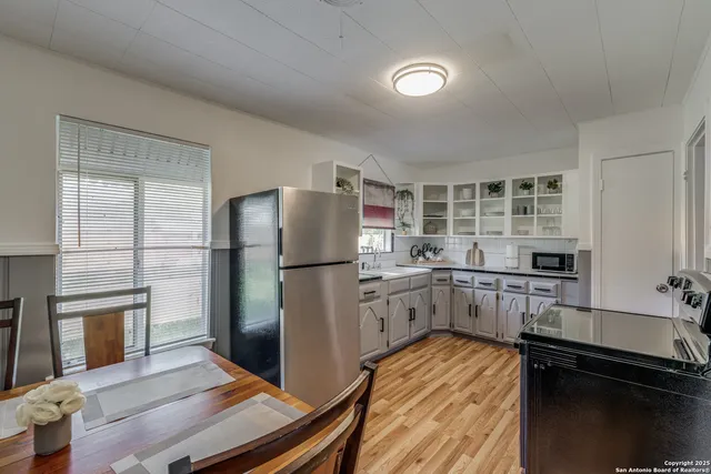 a kitchen with a refrigerator and a stove