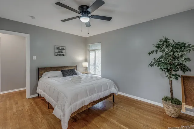 a bedroom with a bed and a potted plant