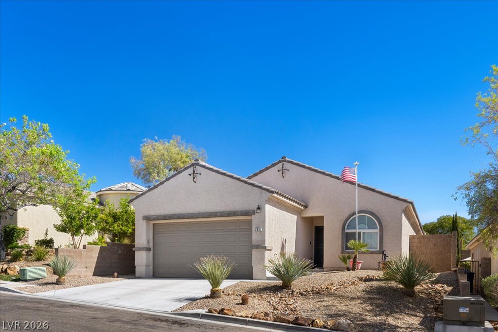 2627 Dirleton Place Henderson, NV 89044 - Photo 35 of 42 A desert-friendly landscape surrounds this charming stucco residence with an attached garage.