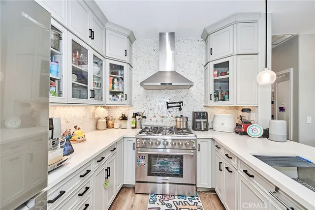 a kitchen with stainless steel appliances a sink stove and cabinets