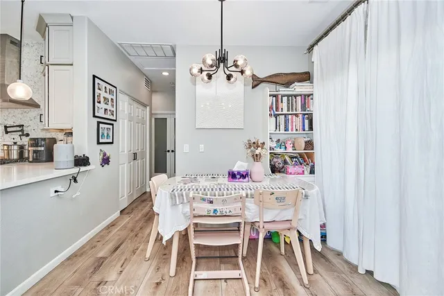 a view of a dining room with furniture and a chandelier
