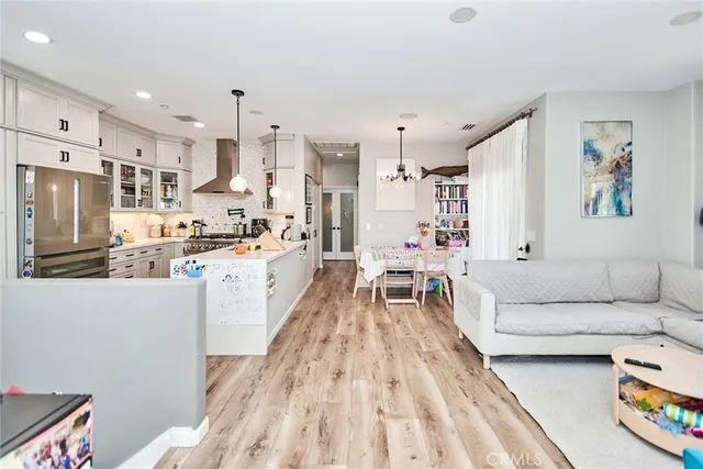 a living room with kitchen island furniture and a kitchen view