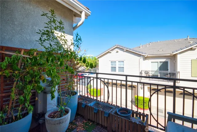 a view of a balcony with wooden floor and outdoor seating