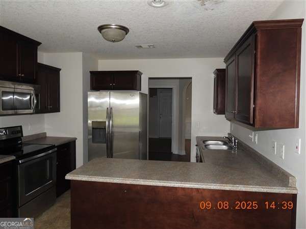 222 Prospect Loop Midway, GA 31320 - Photo 5 of 15 a kitchen with a sink refrigerator and microwave