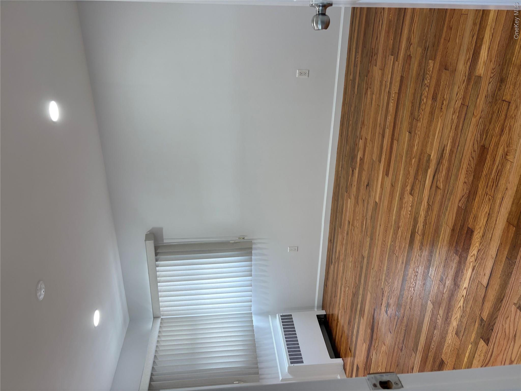 2262 Leighton Road Elmont, NY 11003 - Photo 3 of 12 a view of room with window and wooden floor
