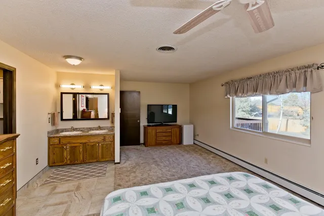 a living room with stainless steel appliances kitchen island granite countertop a refrigerator and a stove