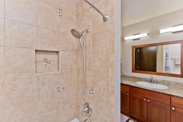 a bathroom with a granite countertop sink mirror and double