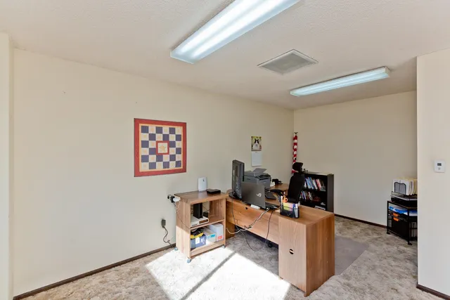 a living room with furniture and a dining table