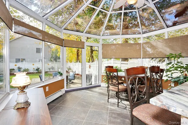 a view of a dining room with furniture a rug and wooden floor
