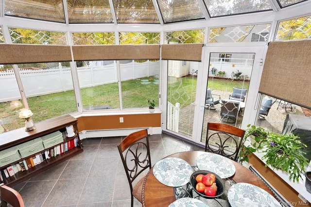 a dining room with furniture and wooden floor