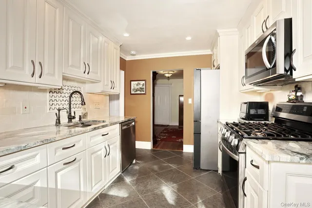 a kitchen with stainless steel appliances granite countertop a sink and cabinets
