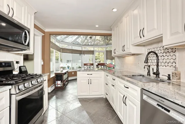 a kitchen with stainless steel appliances a stove sink and cabinets