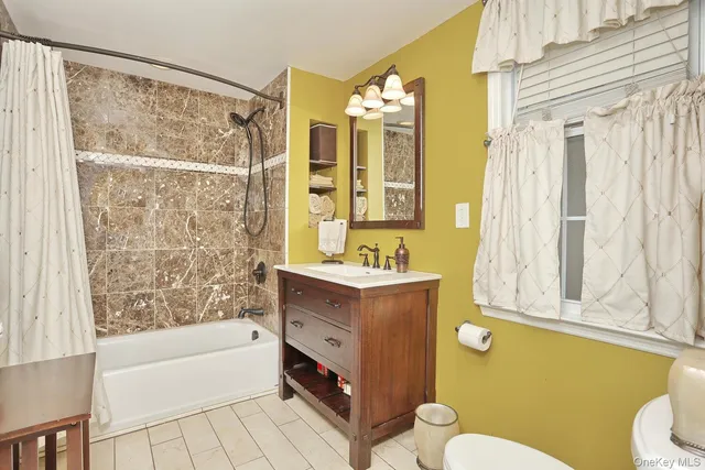 a view of front door with hallway and wooden floor