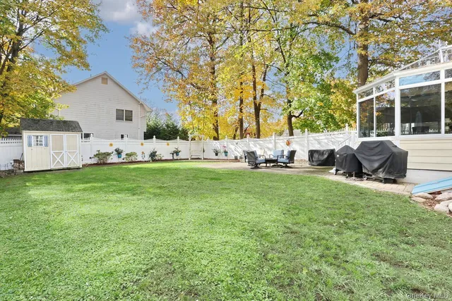 a view of house with backyard