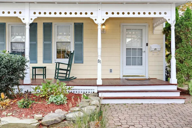 a front view of a building with potted plants