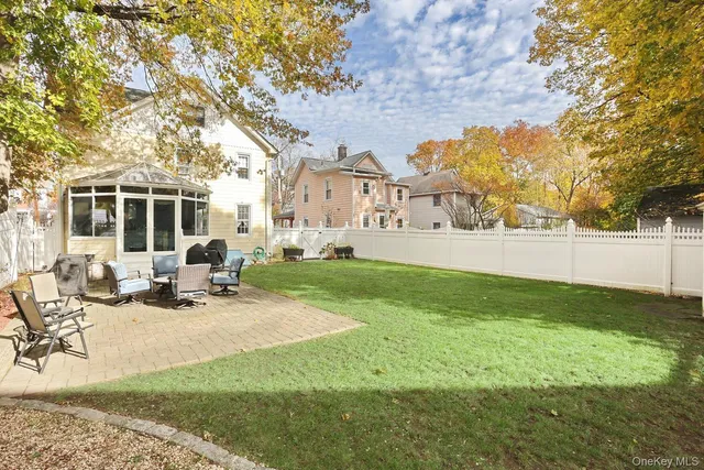 a view of a house with backyard sitting area and garden