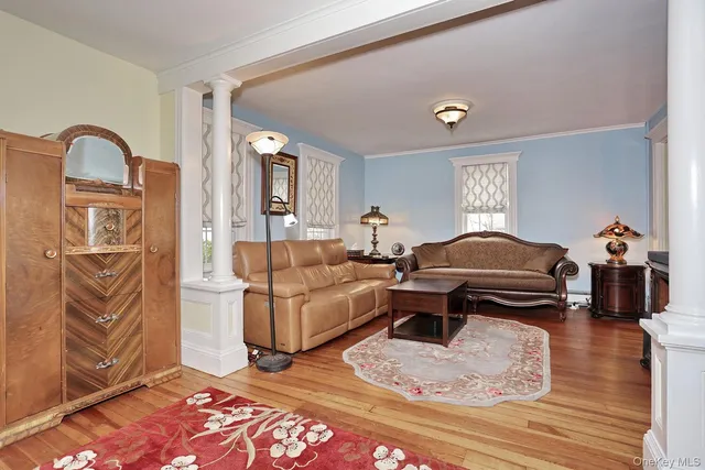 a bedroom with furniture and wooden floor