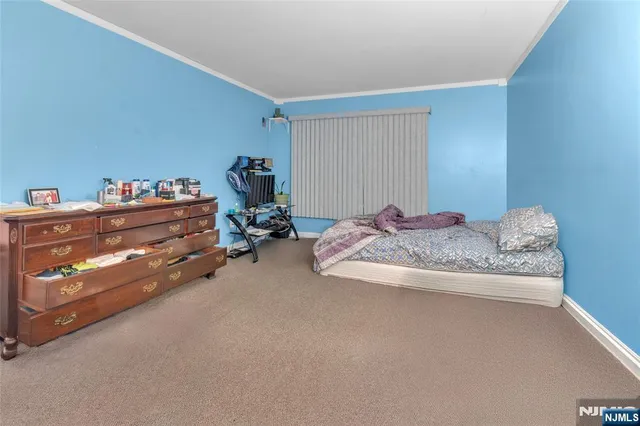 a bed room with a bed and a lamp on desk