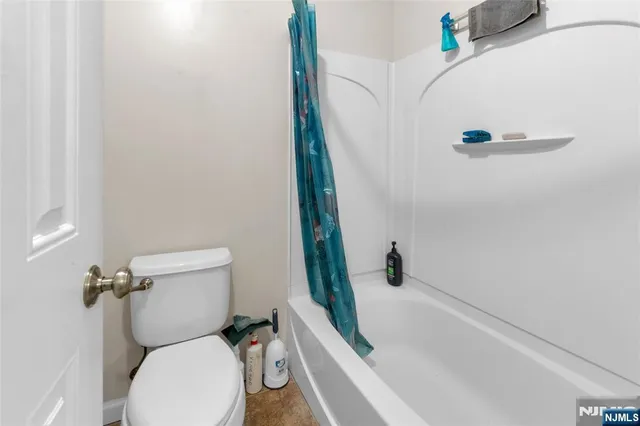 a bathroom with a toilet and a tub