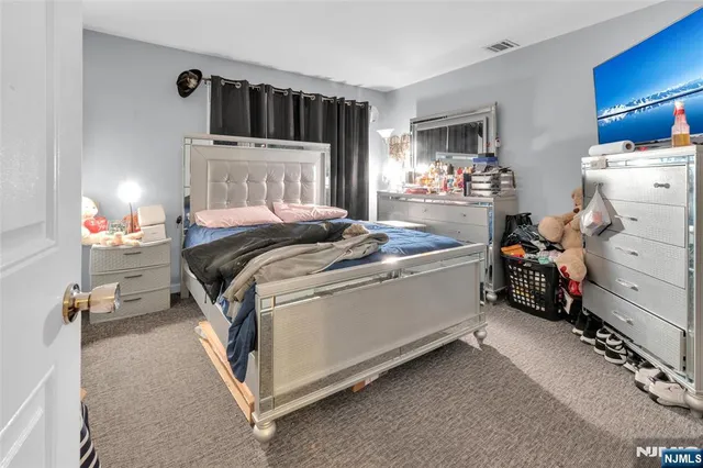 a bed room with a bed and a chair