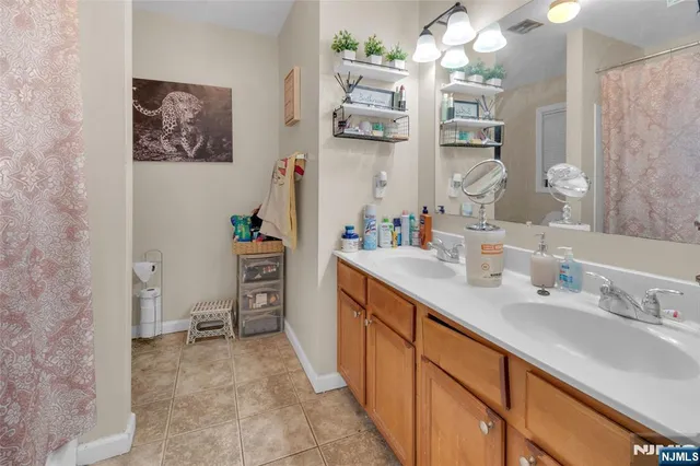 a spacious bathroom with a double vanity sink mirror and double