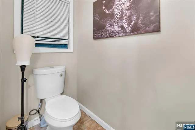 a white toilet sitting next to a white wall