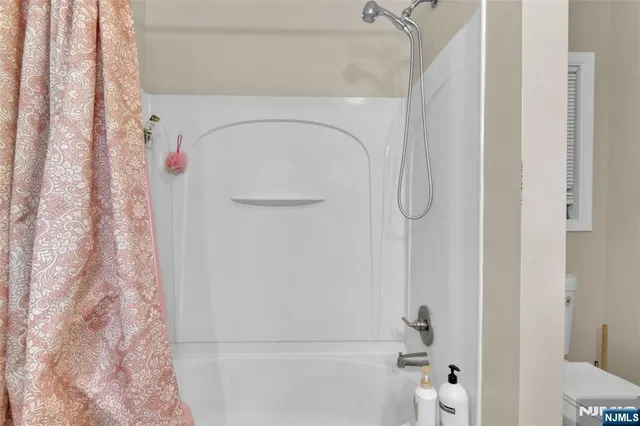 a bathroom with a shower curtain and a toilet