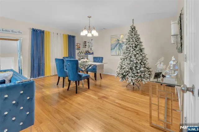 a view of a dining room with furniture and chandelier