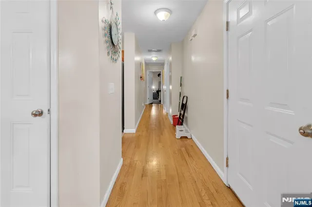 a view of a hallway with wooden floor
