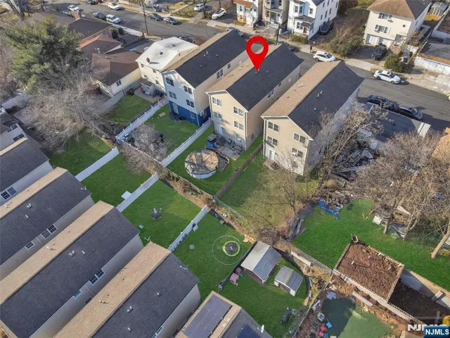an aerial view of a house with garden space and street view