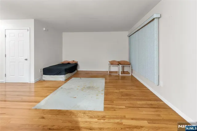 a living room with wooden floor and furniture