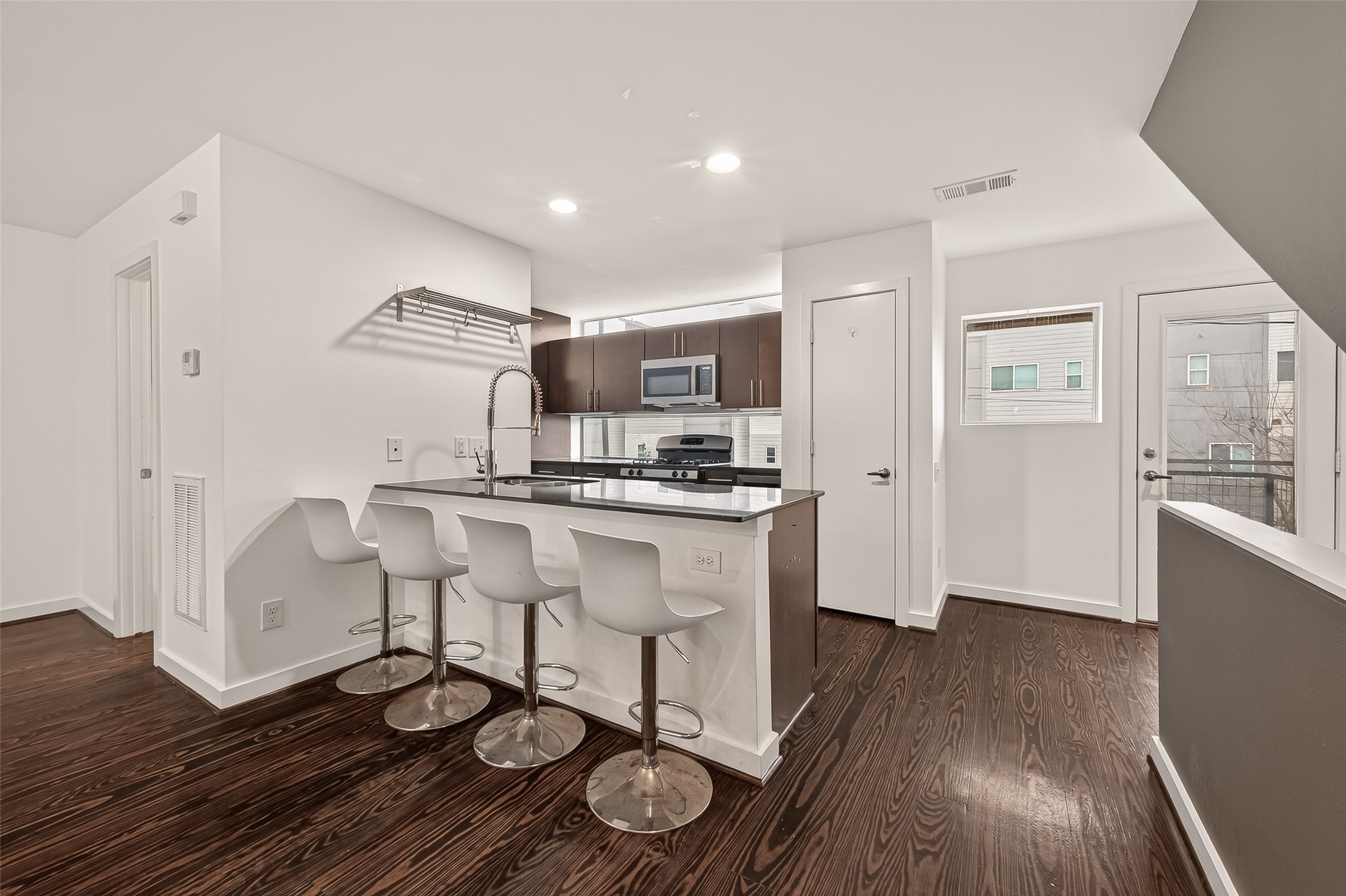 417 Meadow Street Houston, TX 77020 - Photo 12 of 35 a kitchen with stainless steel appliances a dining table chairs and wooden floor