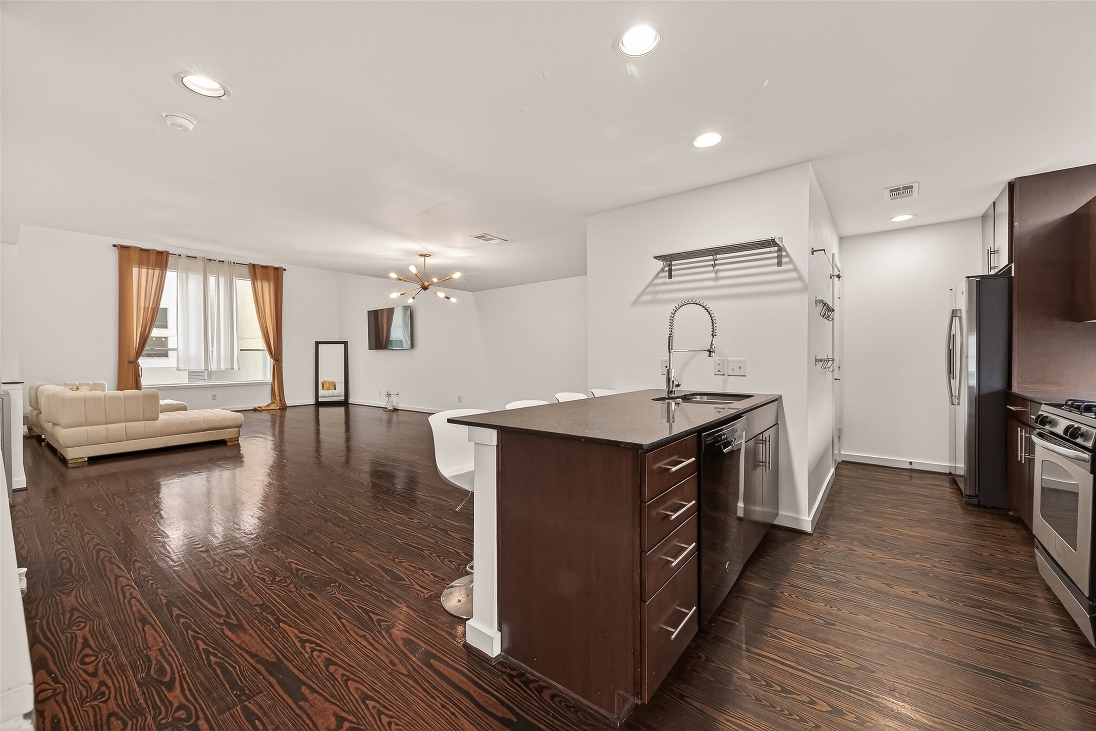 417 Meadow Street Houston, TX 77020 - Photo 13 of 35 a kitchen with stainless steel appliances granite countertop a sink a stove a refrigerator cabinets and wooden floor