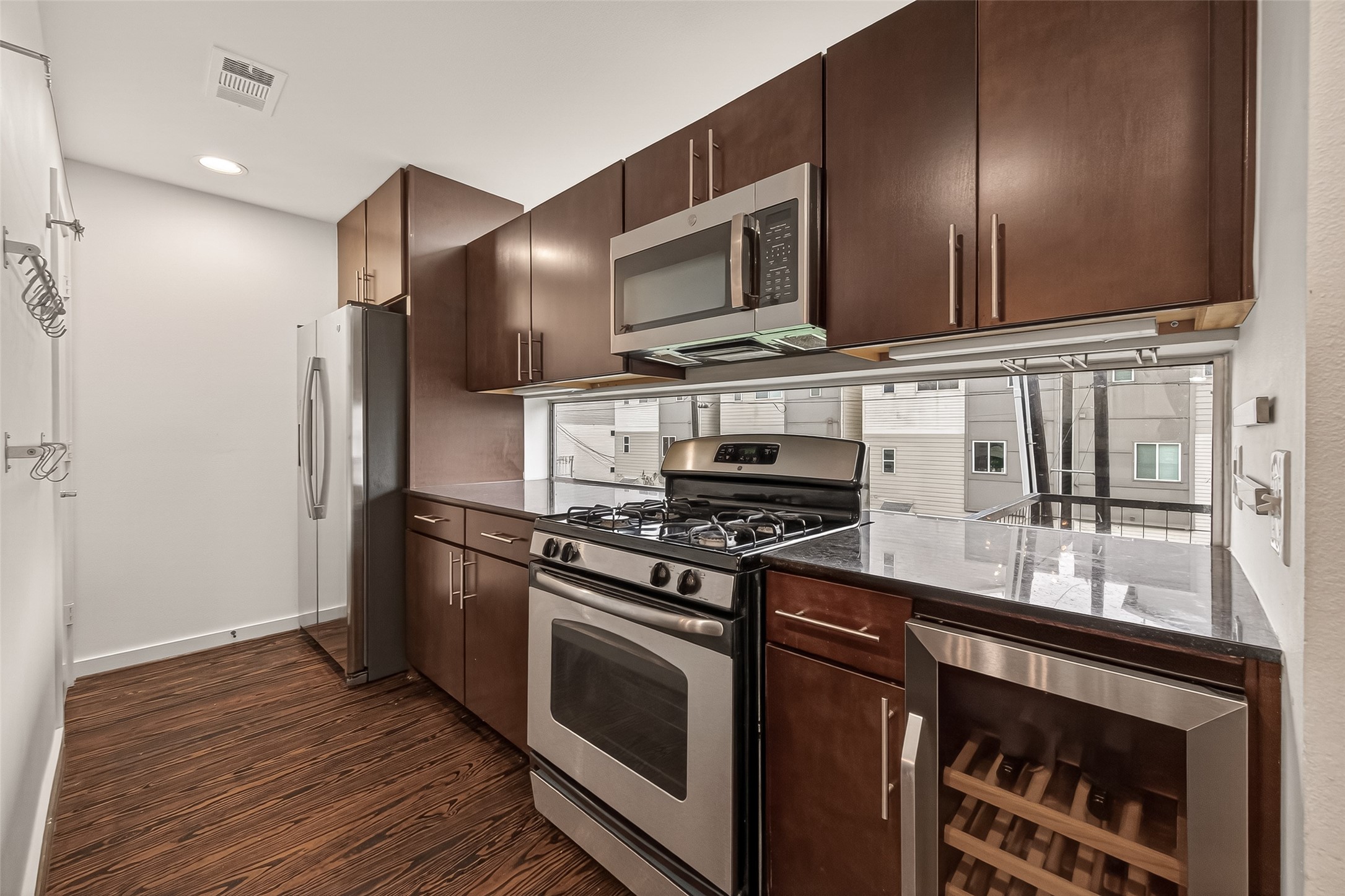 417 Meadow Street Houston, TX 77020 - Photo 14 of 35 a kitchen with stainless steel appliances granite countertop a stove and a refrigerator