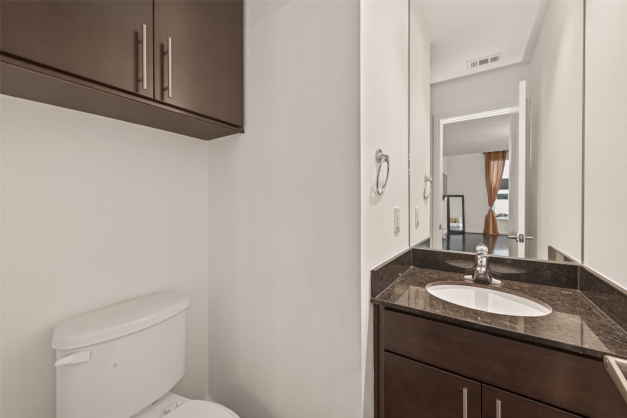 417 Meadow Street Houston, TX 77020 - Photo 17 of 35 a bathroom with a granite countertop sink and a mirror