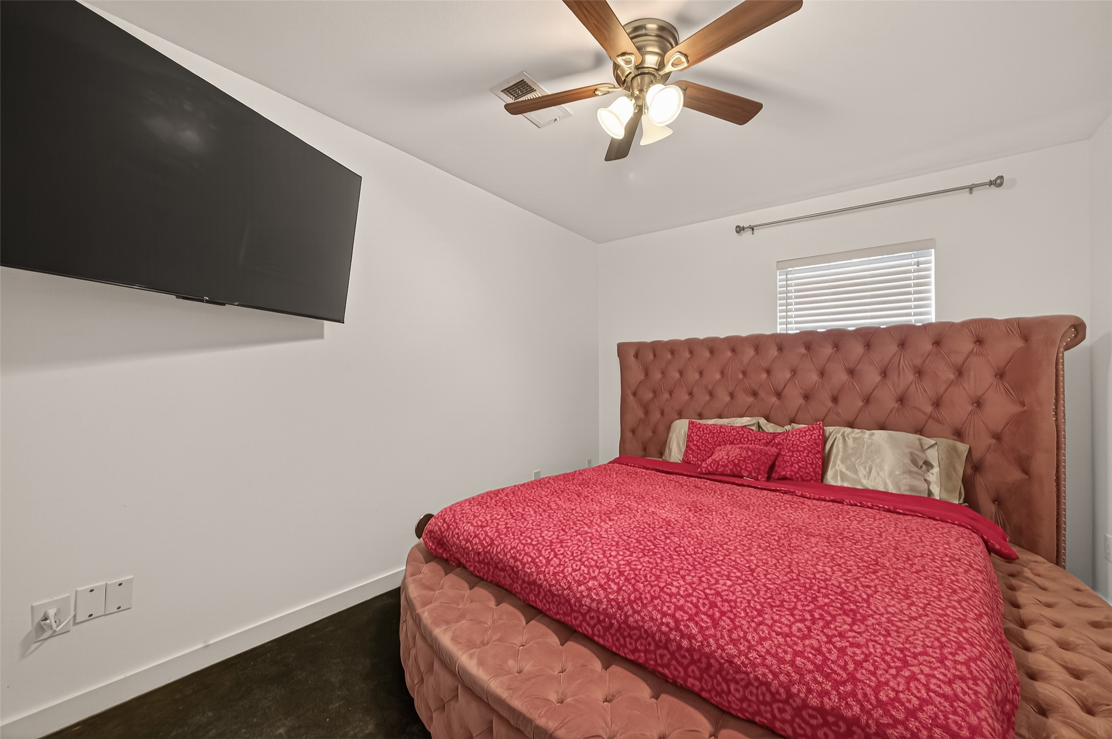417 Meadow Street Houston, TX 77020 - Photo 20 of 35 a bedroom with a bed and a chandelier