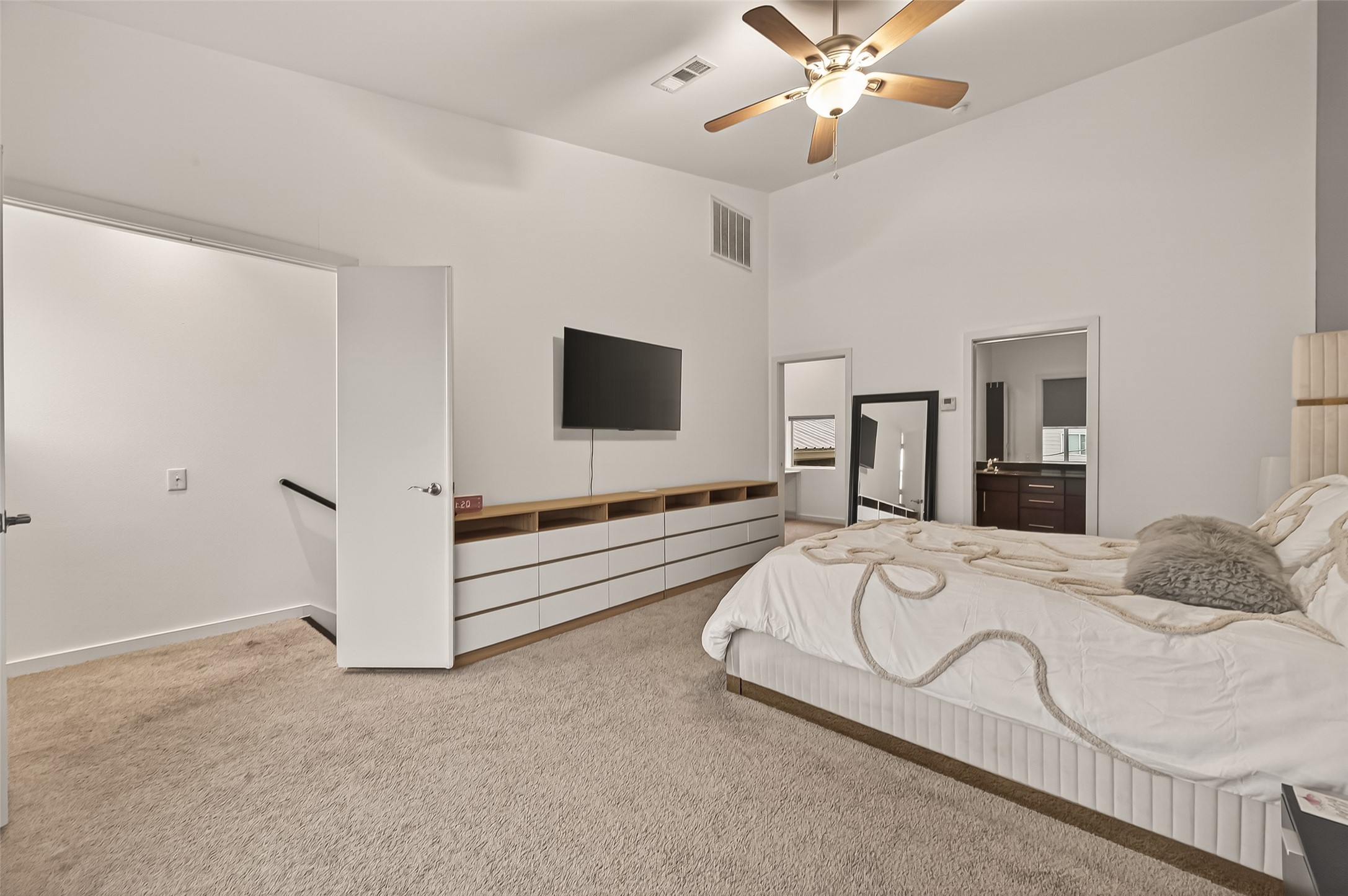 417 Meadow Street Houston, TX 77020 - Photo 24 of 35 a spacious bedroom with a bed and a flat screen tv