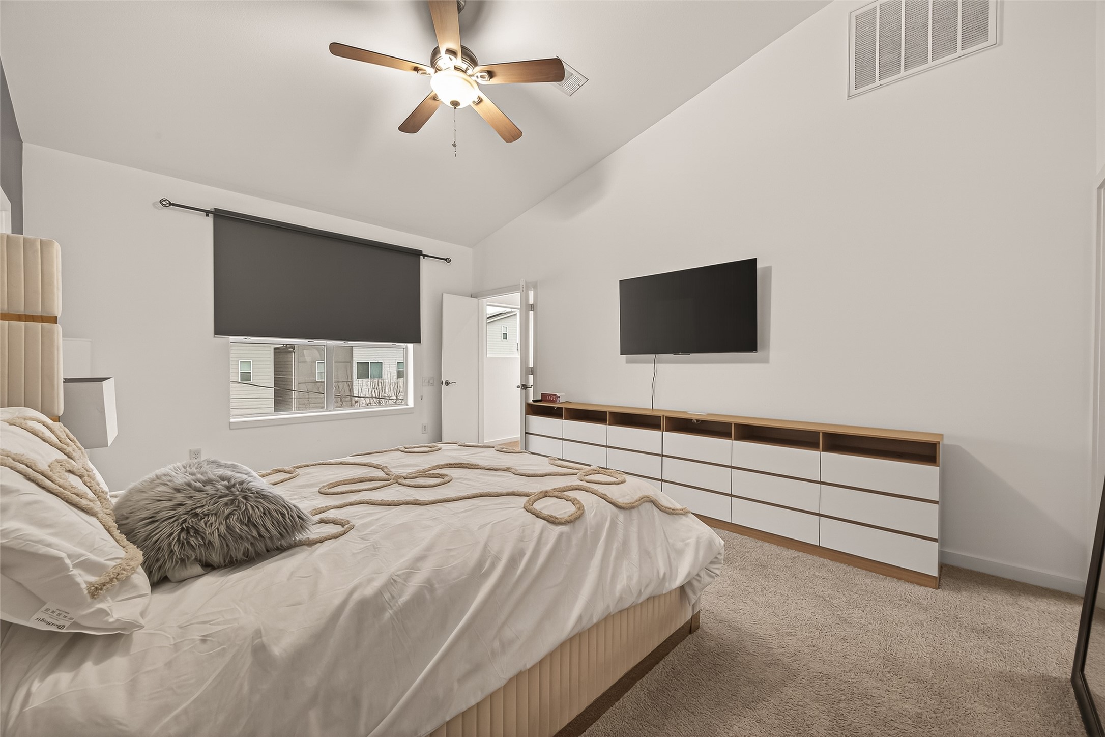 417 Meadow Street Houston, TX 77020 - Photo 25 of 35 a bedroom with a bed and a flat screen tv