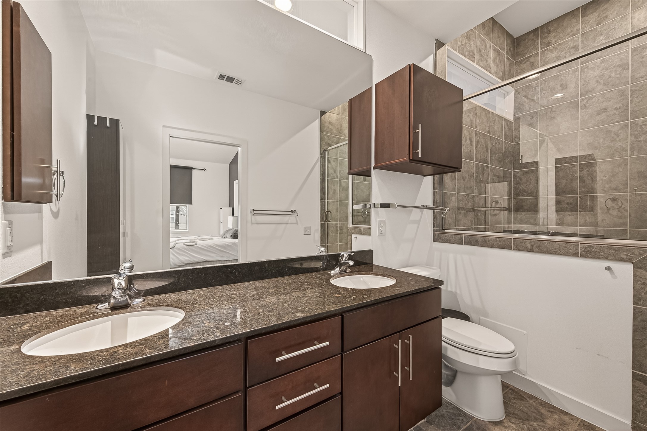 417 Meadow Street Houston, TX 77020 - Photo 26 of 35 a bathroom with a granite countertop sink and a mirror with toilet