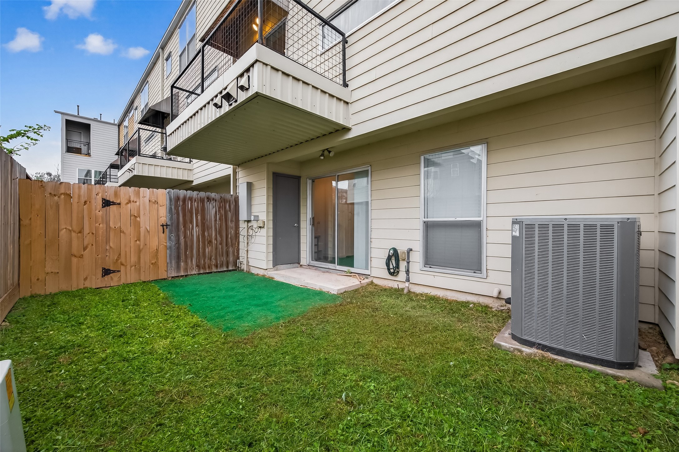 417 Meadow Street Houston, TX 77020 - Photo 34 of 35 a backyard of a house with lots of green space and wooden fence