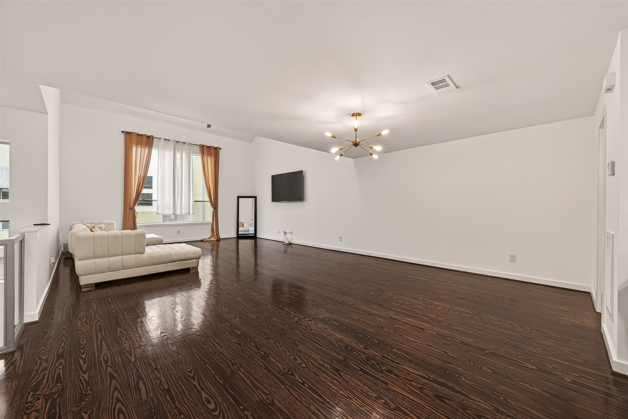 417 Meadow Street Houston, TX 77020 - Photo 10 of 35 a view of a livingroom with furniture wooden floor chandelier and windows