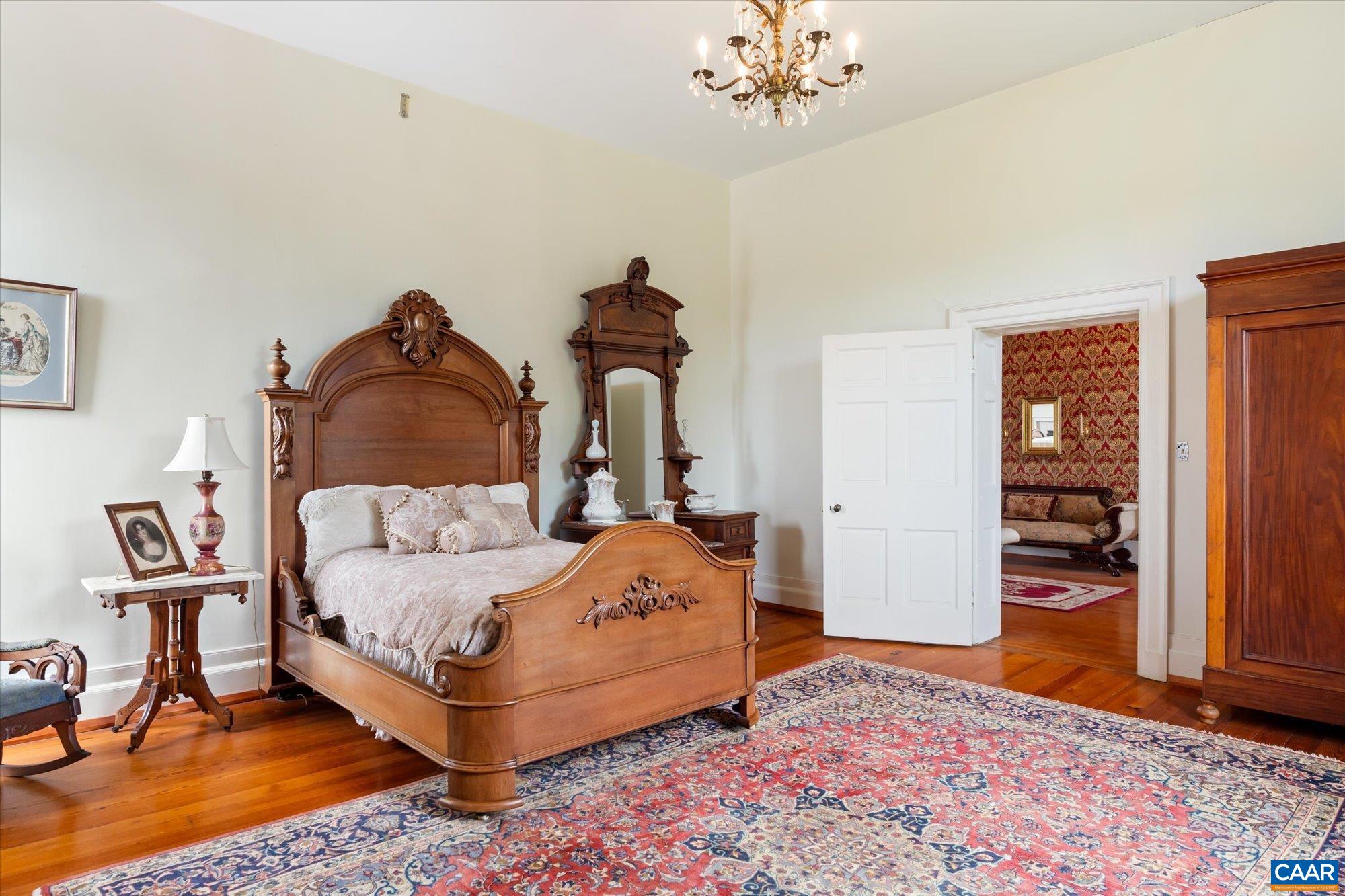 325 Factory Outlet Drive Max Meadows, VA 24360 - Photo 27 of 67 a bedroom with a bed and a chandelier