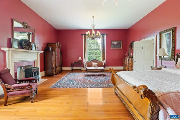 a living room with fireplace furniture and a chandelier