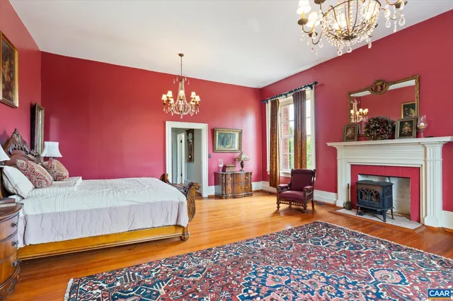 a spacious bedroom with a bed and dresser