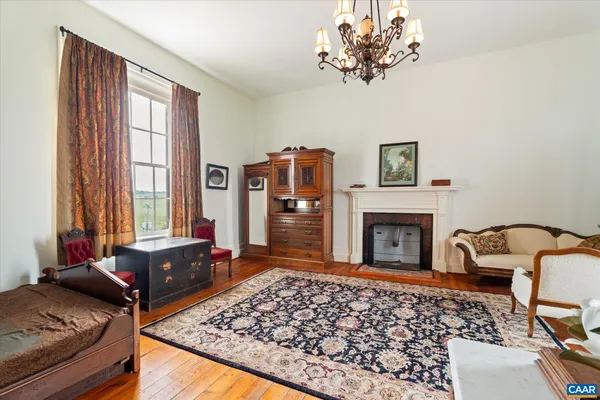 a dining room with furniture a fireplace and wooden floor