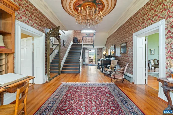 a dining room with furniture a rug and a fireplace