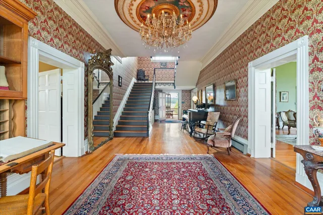 a dining room with furniture a rug and a fireplace