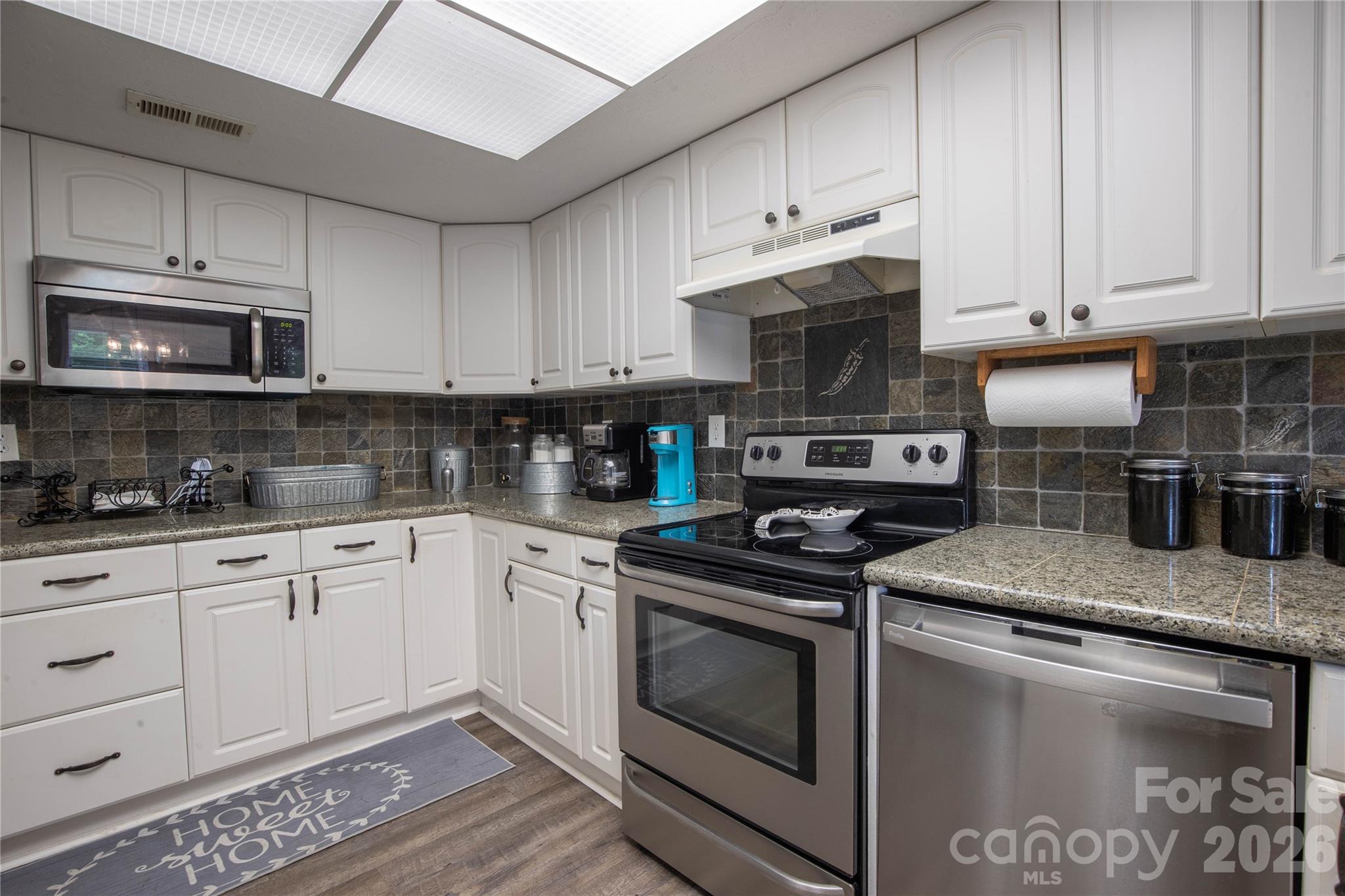 84 Sheets Farm Road Bakersville, NC 28705 - Photo 14 of 42 a kitchen with stainless steel appliances granite countertop a stove a sink and a microwave