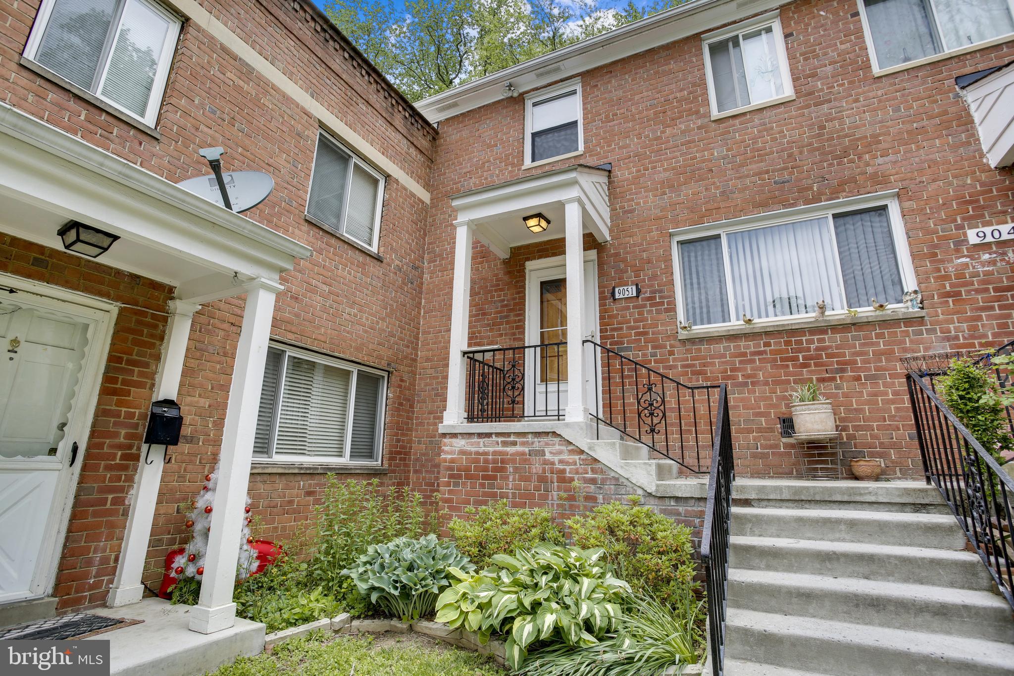 9051 Manchester Road Silver Spring, MD 20901 - Photo 1 of 37 a front view of a house with a garden